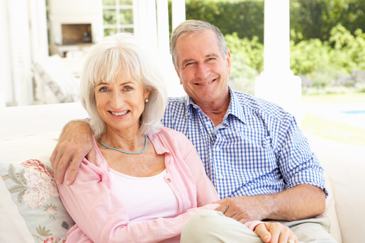 Happy senior couple on sofa