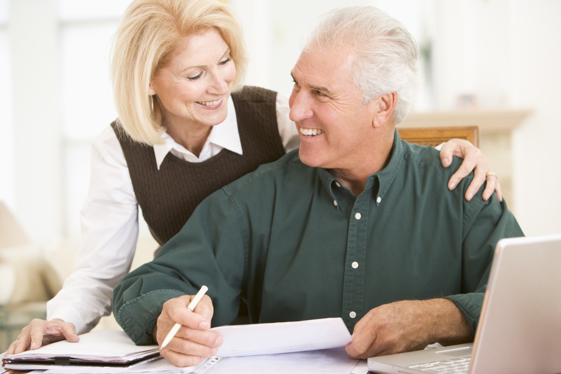 Happy senior couple doing paperwork